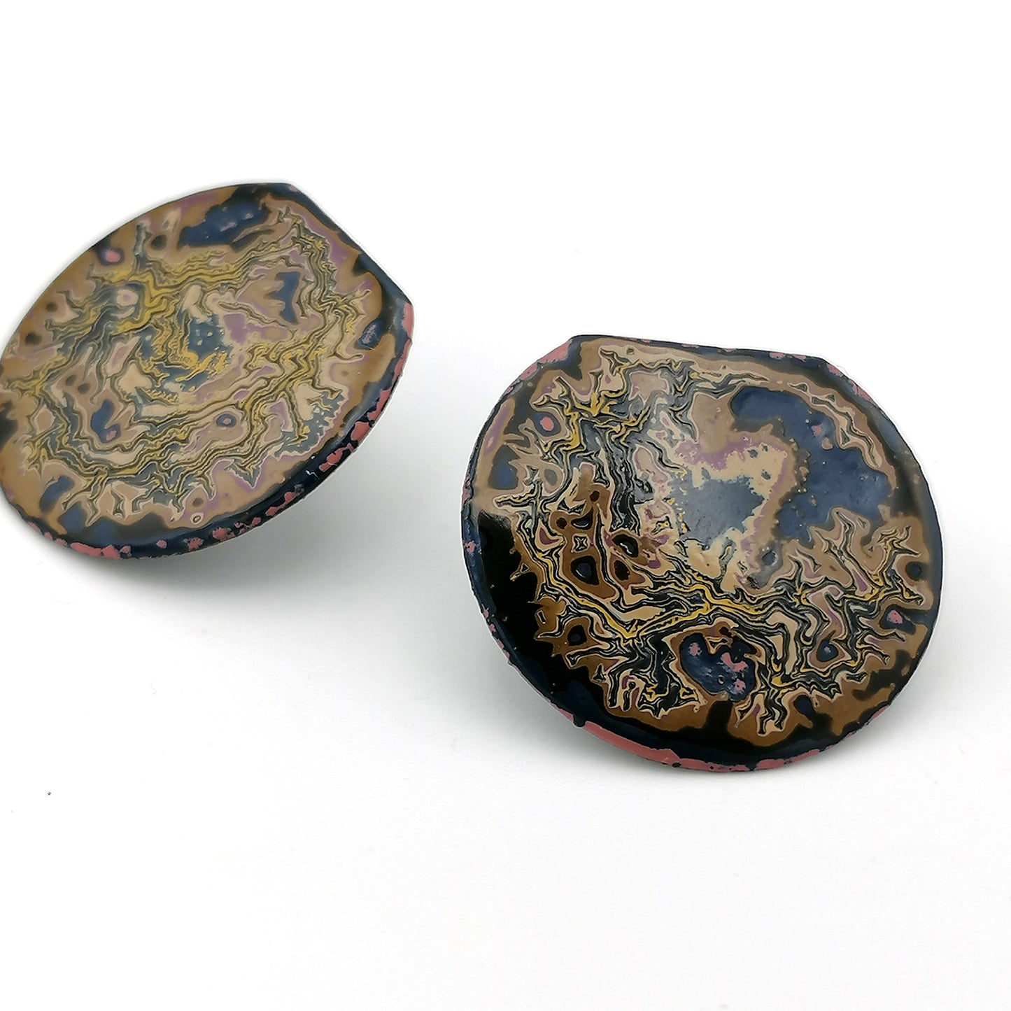 Image shows two round stud earrings with the top portion cut off. Earring shows a wrinkled pattern with yellow deep blue and beige.
